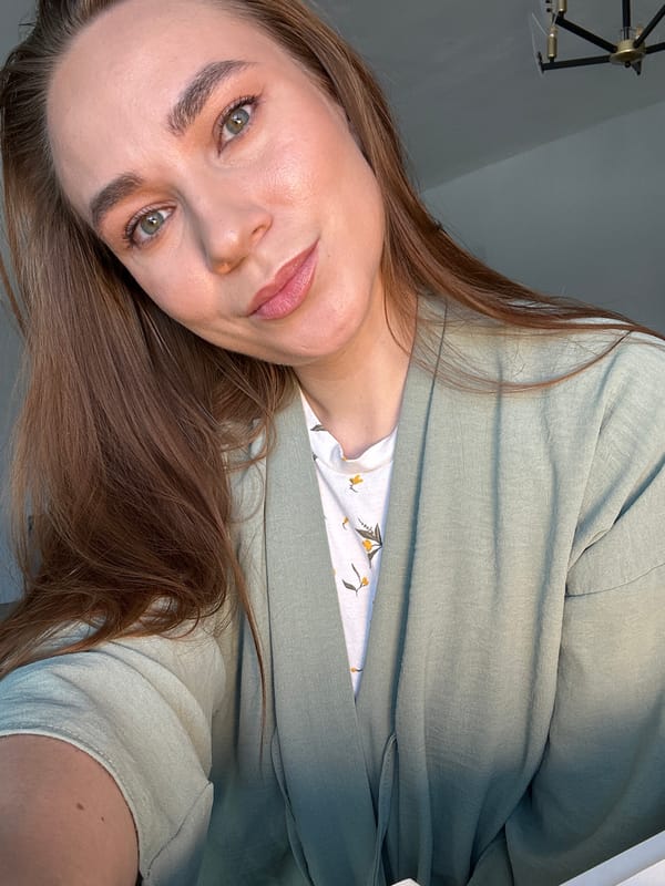 Woman takes selfies while applying makeup in Russian home