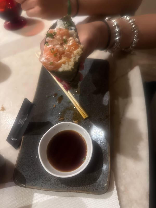 Diner enjoys salmon temaki at Japanese restaurant in Loures