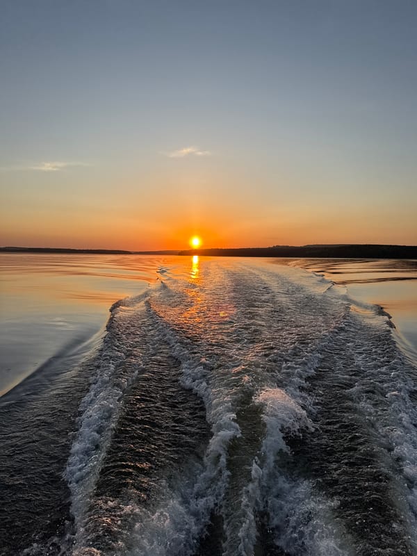 Sunset creates golden reflection over choppy Votkinsk Reservoir waters