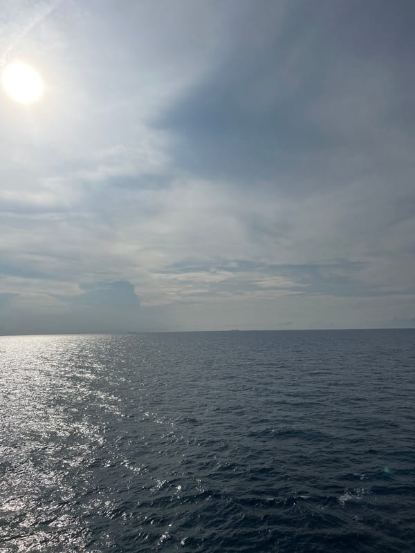 Sun cuts through clouds over open South China Sea waters