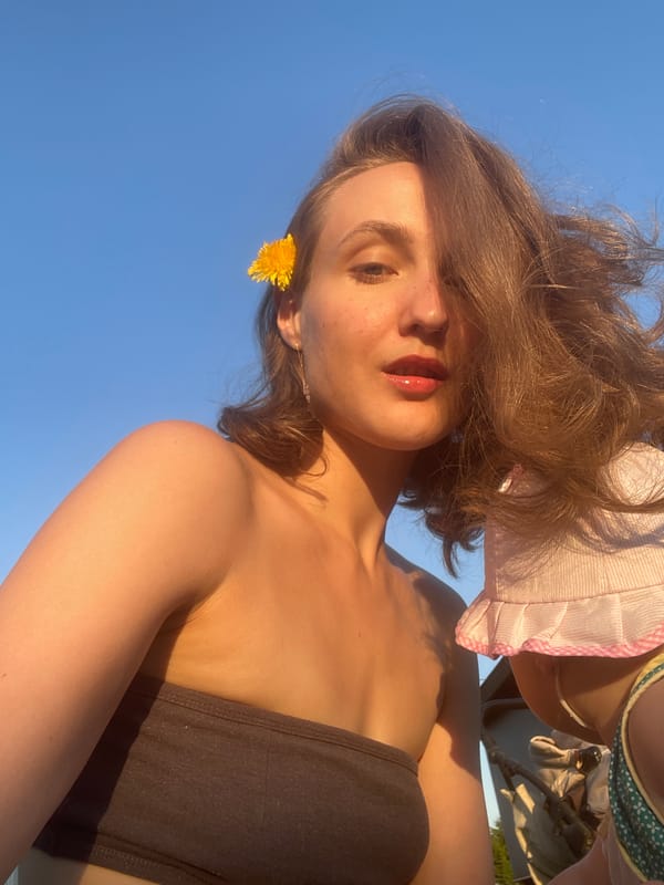 Woman poses with dandelions in outdoor photo session, Russia