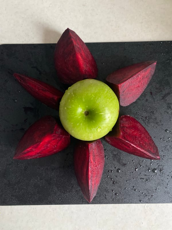 Apple and beet wedges arranged on cutting board in Sochi