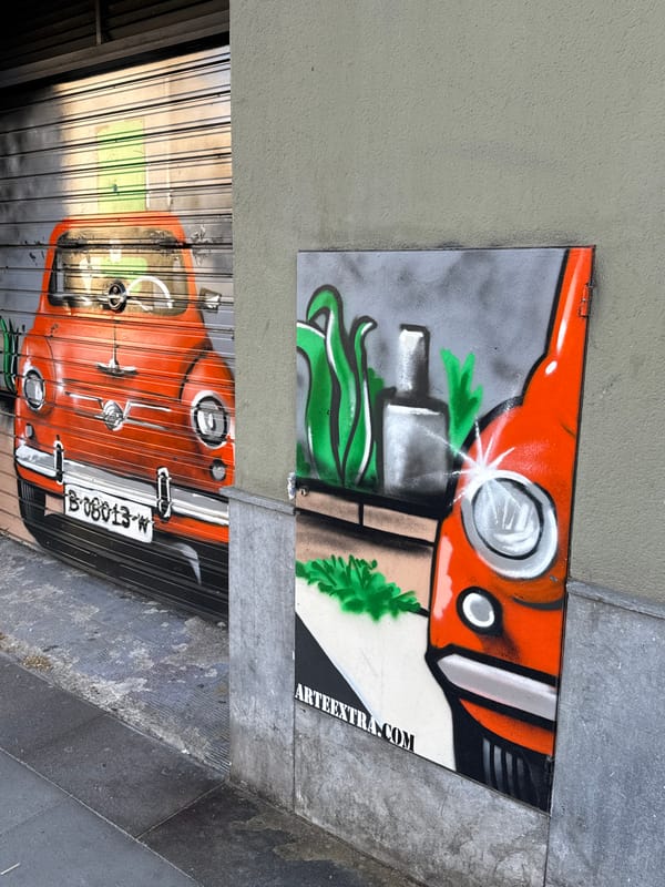 Orange vehicle graffiti art documented on Barcelona metal surfaces