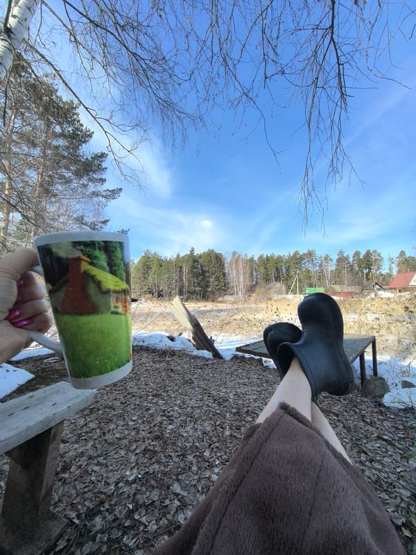 Person relaxing in snowy Russian countryside on sunny morning