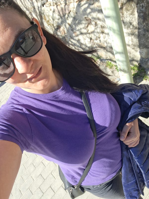 Woman poses outdoors in purple shirt in Goce Delcev