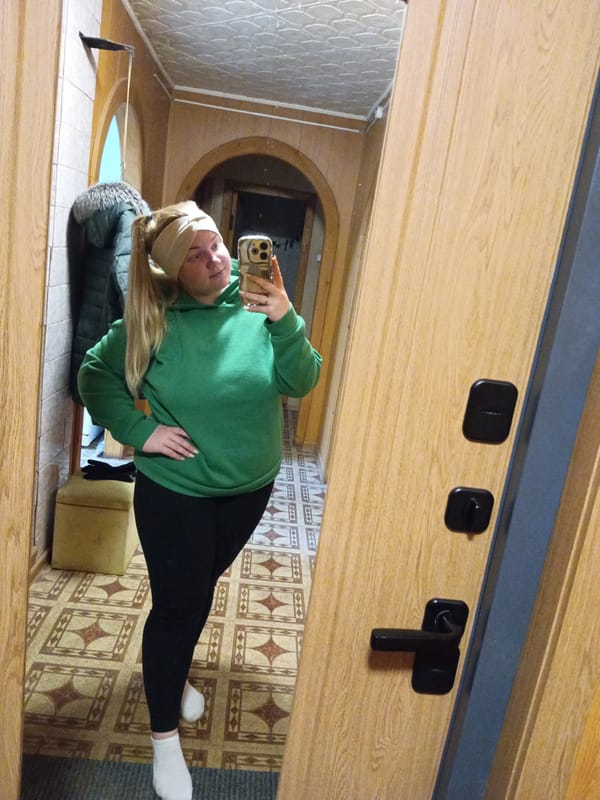 Woman takes mirror selfies in Russian hallway
