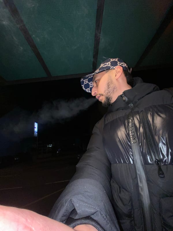 Man smoking at French subway station near boxing event poster