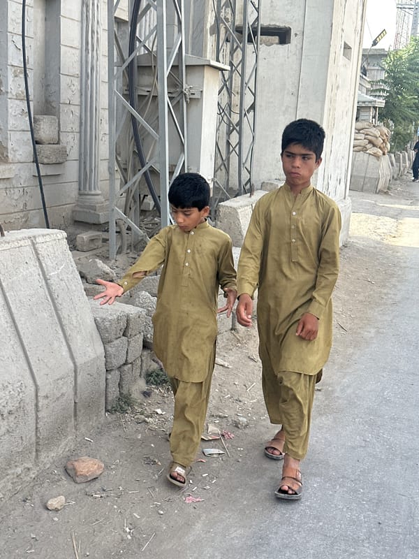 Street scene with pedestrians and motorcycle in Quetta