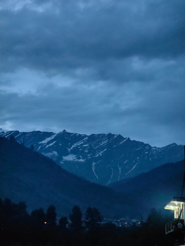 Bahang after dark: street dogs, mountain clouds, and guesthouse lights