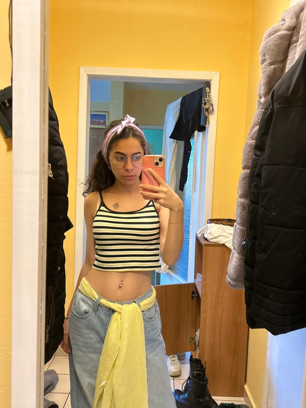 Woman takes mirror selfies in striped top in Sofia