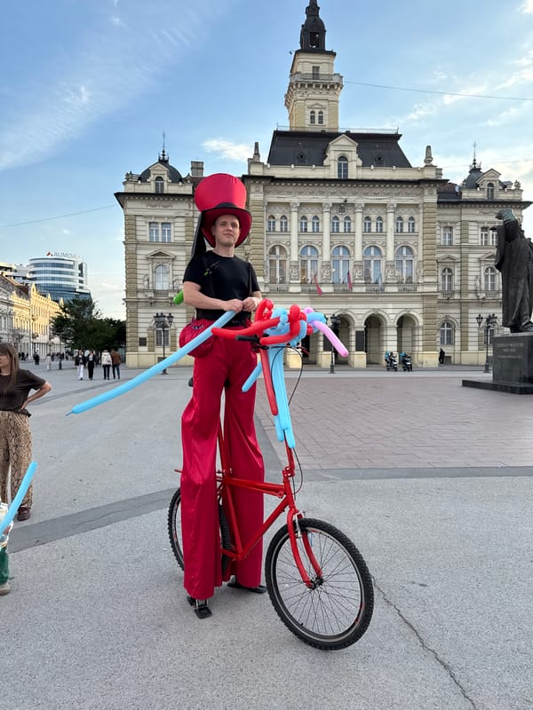 Street performer on decorated bicycle entertains in Novi Sad