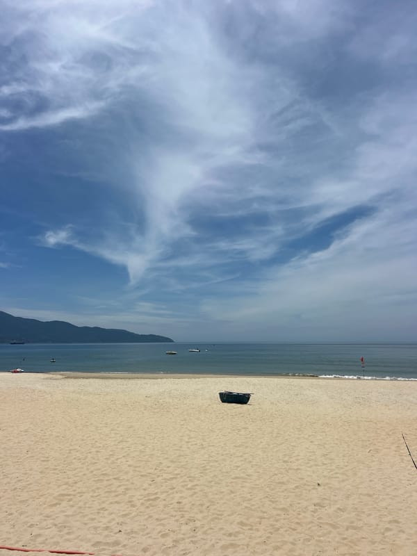 Sunny beach day with volleyball net, umbrellas, and coastal details