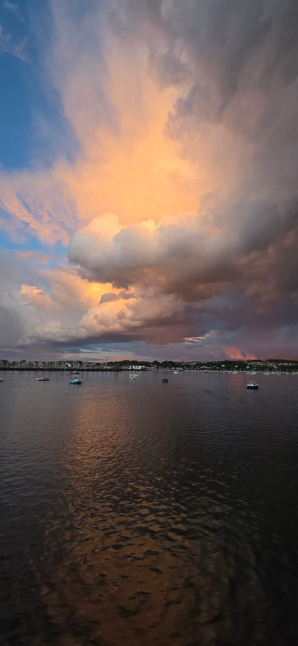 Dramatic sunset captured over Hondarribia waterfront amid storm clouds