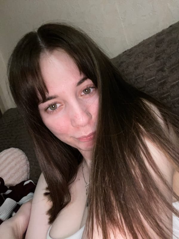 Woman poses for casual photos in Chaikovsky bedroom