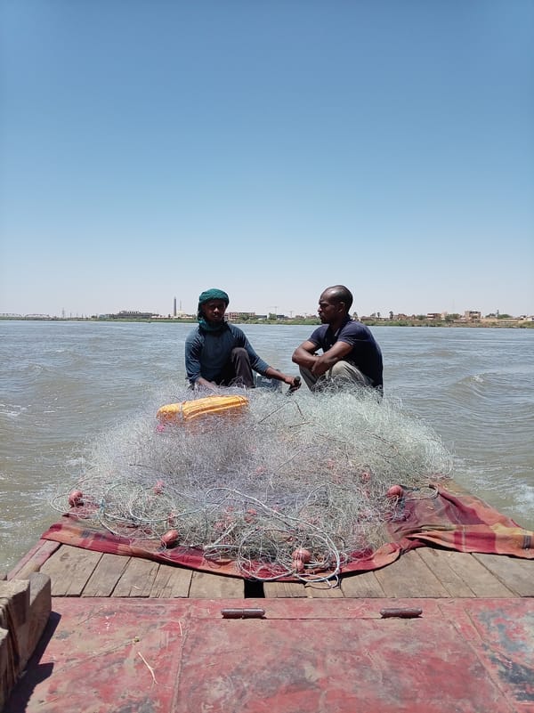 Fishermen work nets on Nile River in Omdurman