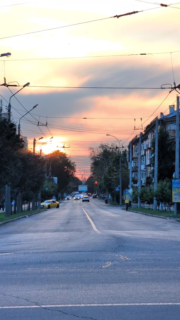 Summer evening street life in an Eastern European city at sunset
