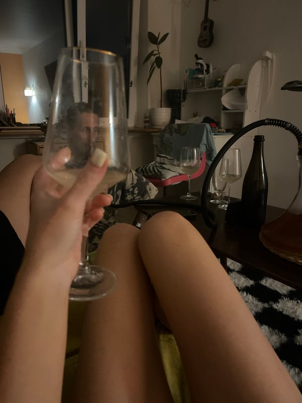 Relaxed evening hangout with wine, a couch, and a checkered rug