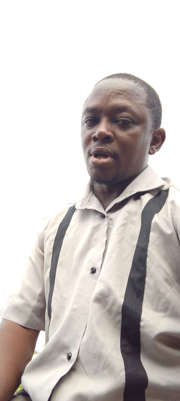 Man cooking outdoors in industrial area, Lokoja Nigeria