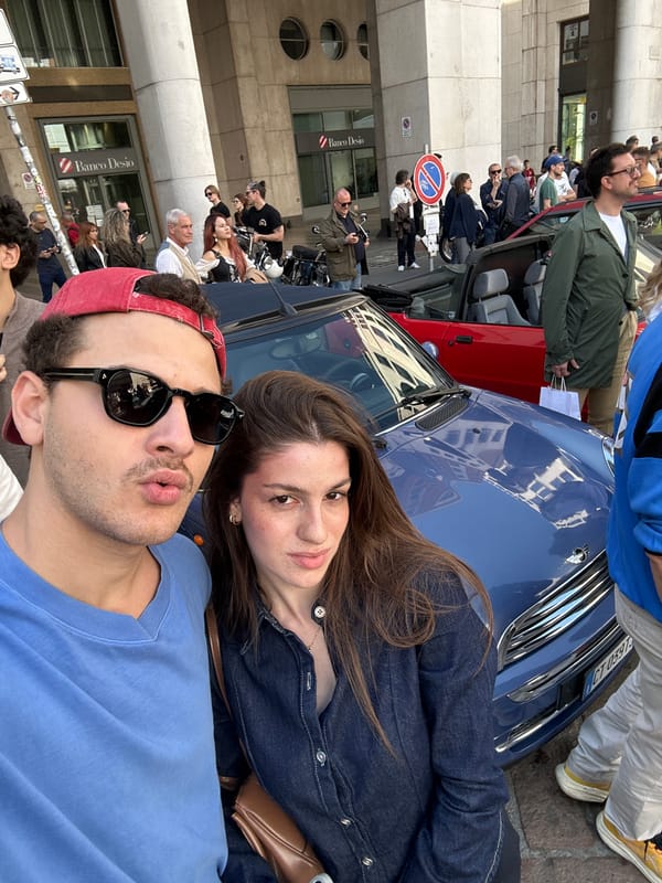 Car enthusiasts pose with vehicles in Milan streets