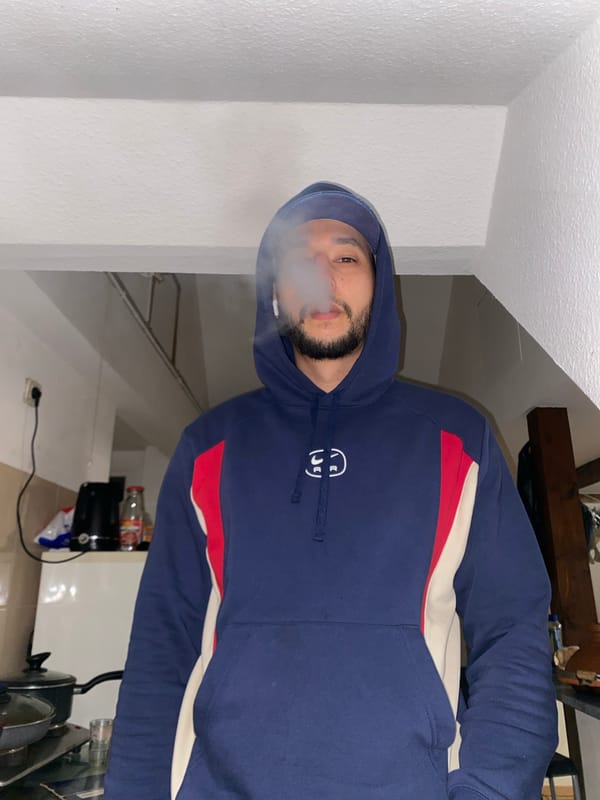 Man smoking indoors in Bischheim kitchen area
