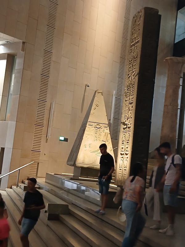 Visitors view Egyptian artifacts at Grand Museum in Giza