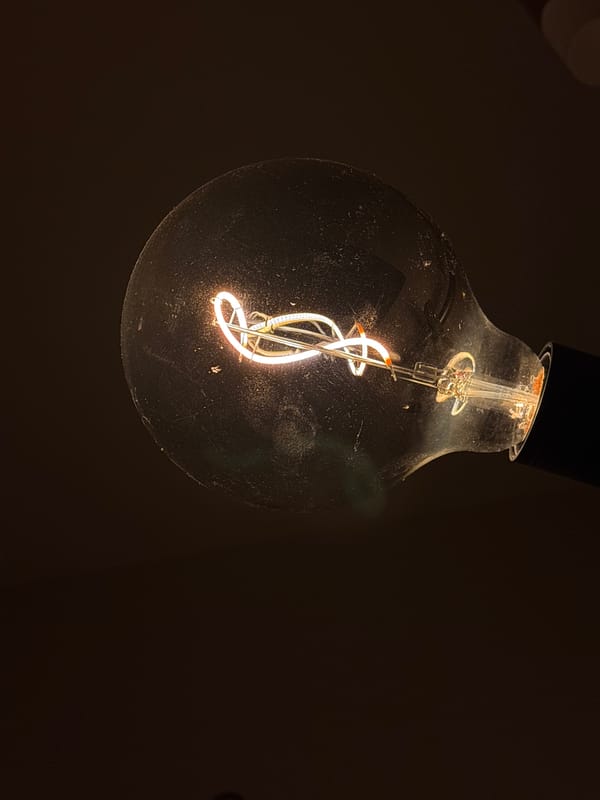 Glowing lightbulb photographed in dimly lit setting