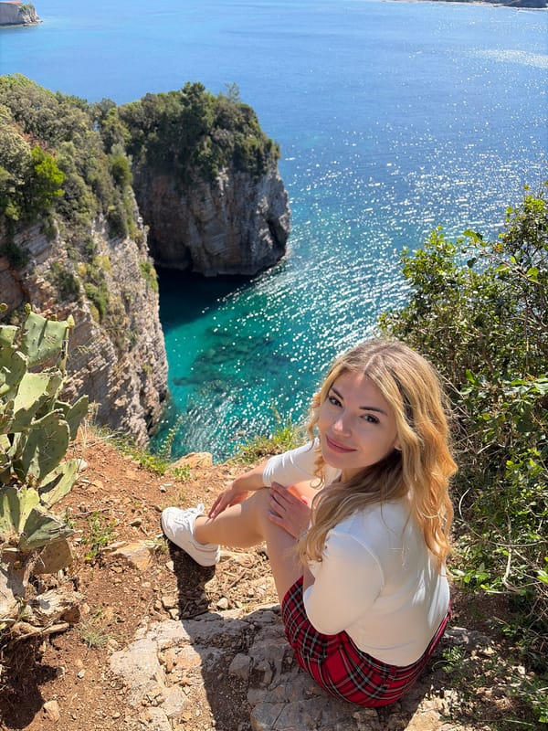 Tourist photographs scenic Adriatic coastline from Budva cliffs