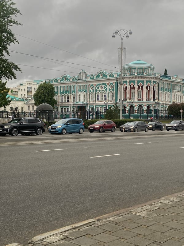 Tourist documents Yekaterinburg landmarks during rainy afternoon walk