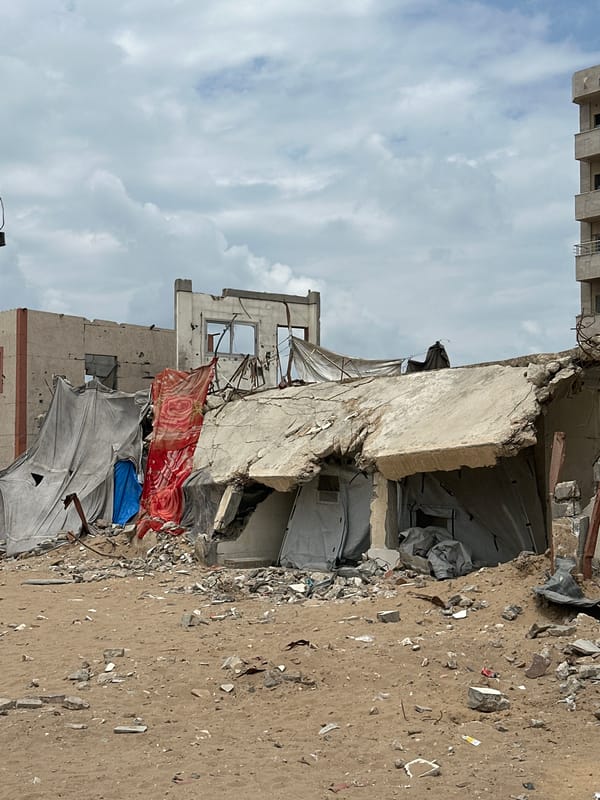 Children carry water, supplies amid Gaza rubble and tents