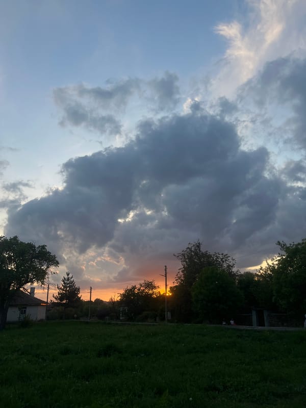 Woman walks through Bulgarian village at dramatic sunset