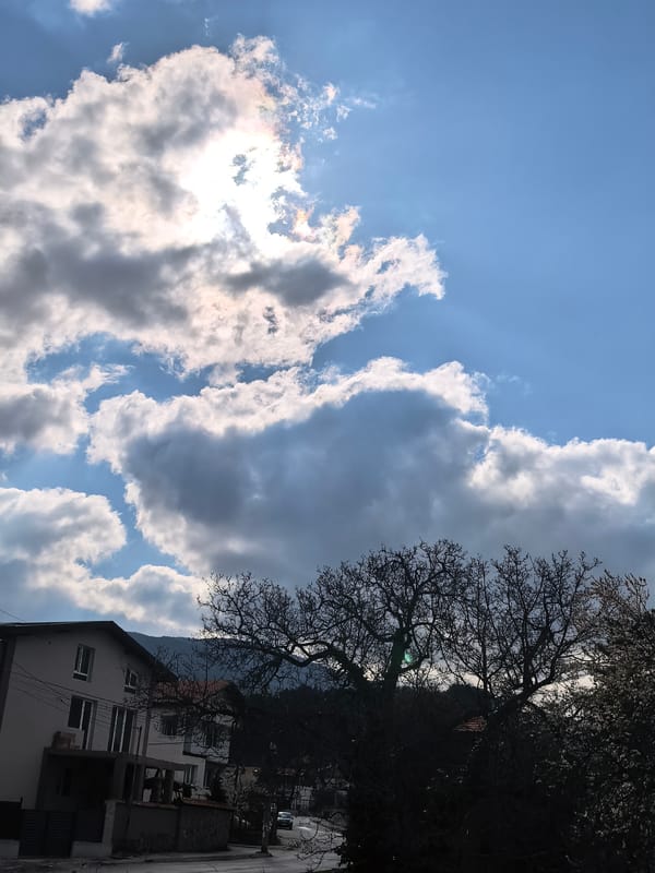 Bright morning sun observed over residential area with clouds