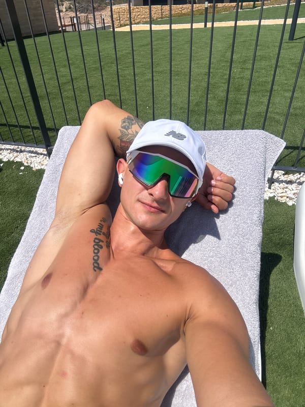 Poolside relaxation under palm trees in sunny Finestrat, Spain.