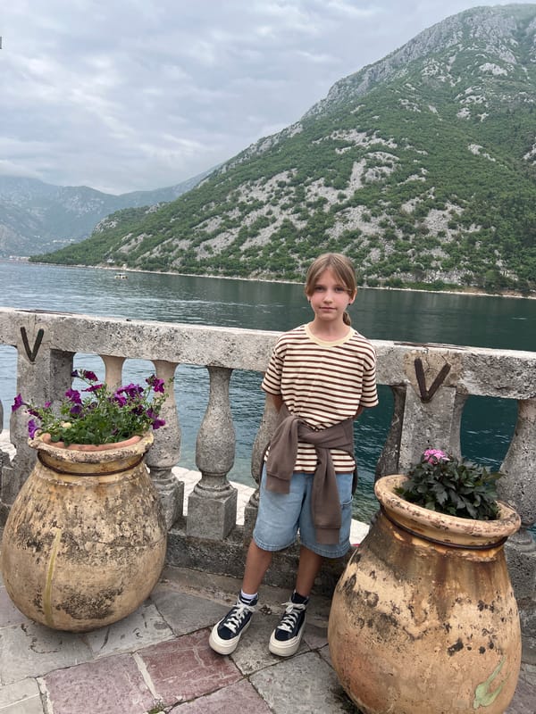 Tourists capture scenic moments in historic Perast, Montenegro
