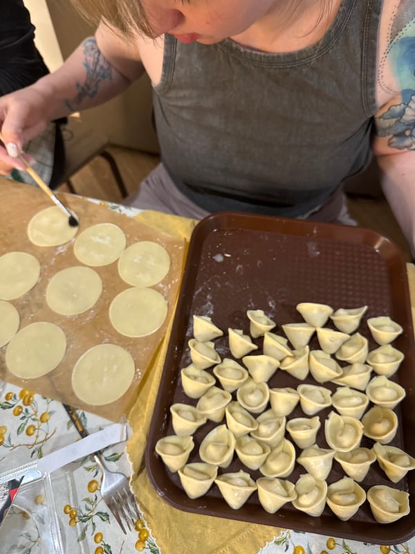 Family dumpling-making session documented in Krasnoyarsk kitchen