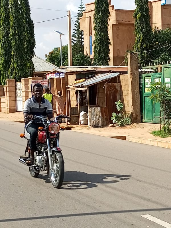 Motorcycle riding through the streets of Tempure, Nigeria