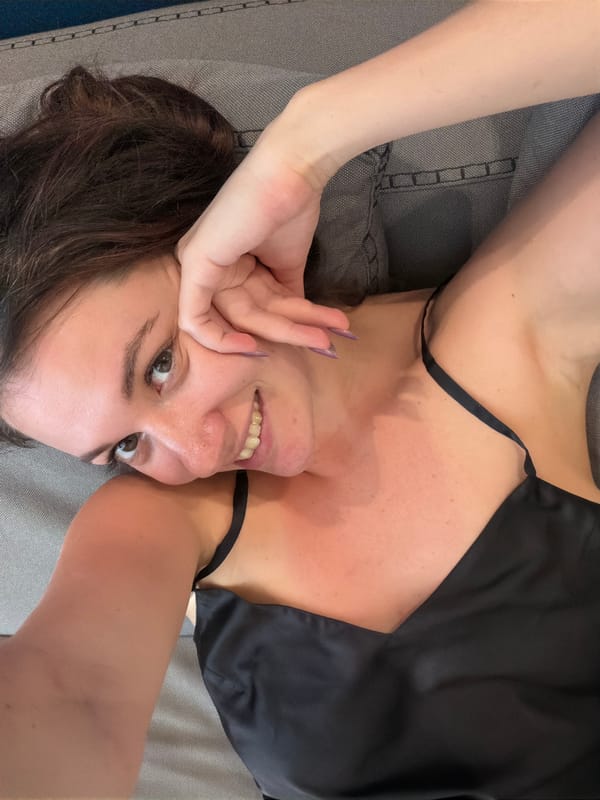 Woman observed resting on grey surface in Athens