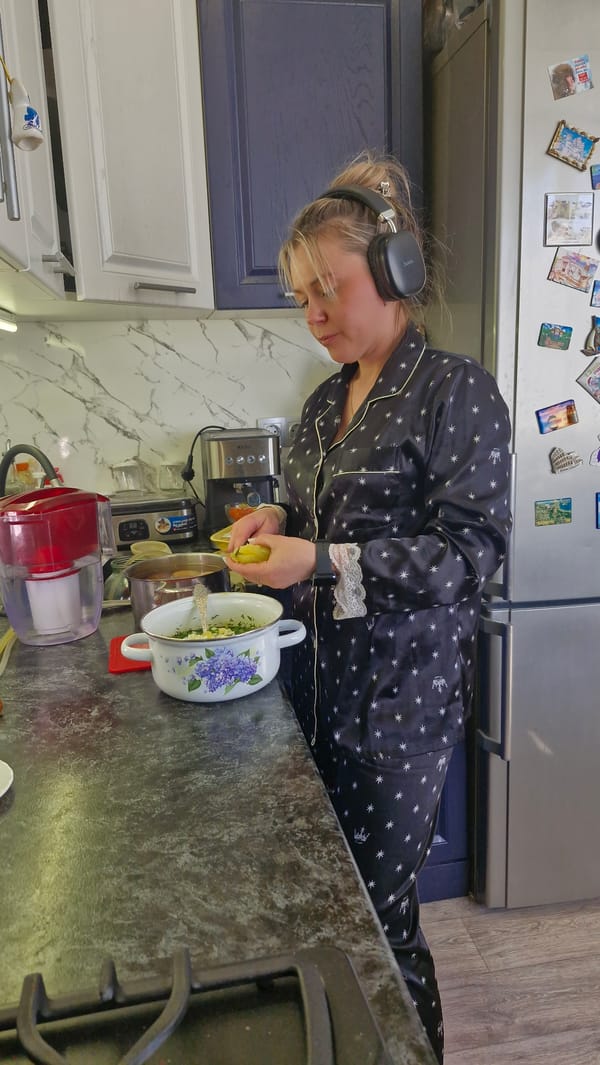 Woman prepares breakfast in kitchen wearing star-patterned pajamas