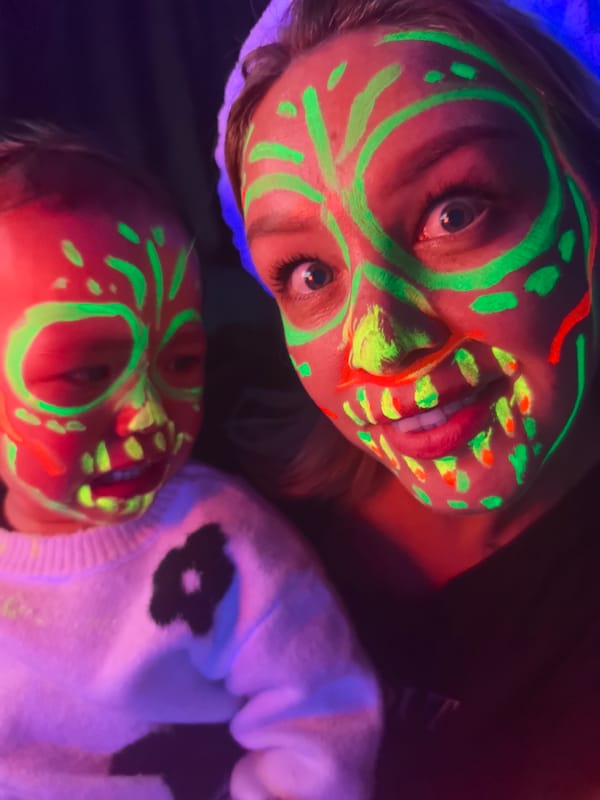 Mother, child sport neon skull paint at Noviy gathering