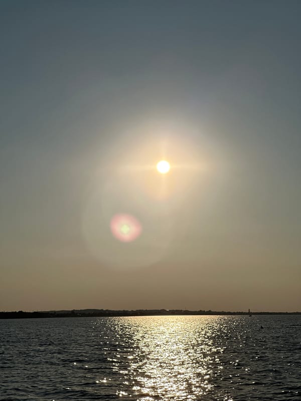 Sun glare and golden reflections over a Kokshetau lake