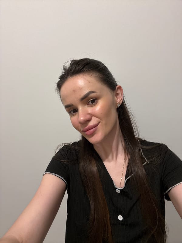 Quick back-to-back selfies against a plain white wall.