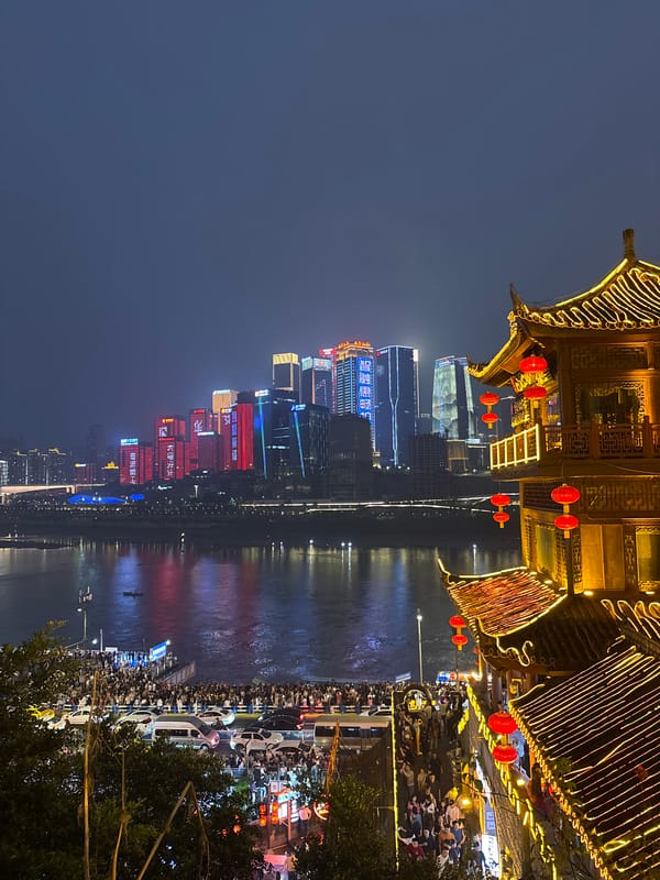Traditional performance captured amid Chongqing's illuminated riverfront skyline
