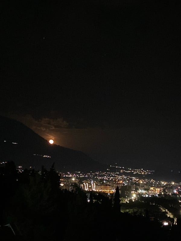 Full moon rises over coastal Montenegro town