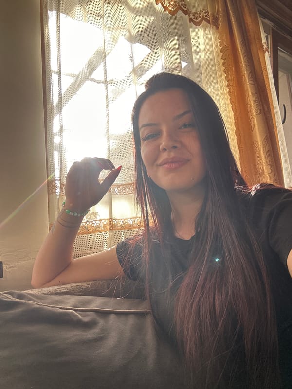 Women take selfies with small dog in Skala home