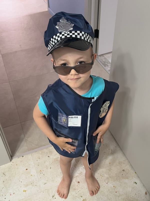 Mother and child play police dress-up in Chaikovsky home