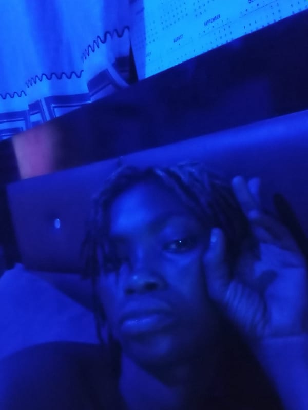 Person rests in blue-lit room in Shagamu, Nigeria