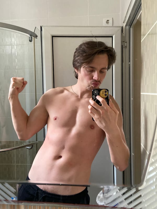 Man takes bathroom mirror selfie in Šušanj, Montenegro