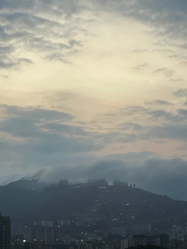 Caracas hillside cityscape documented under cloudy evening skies