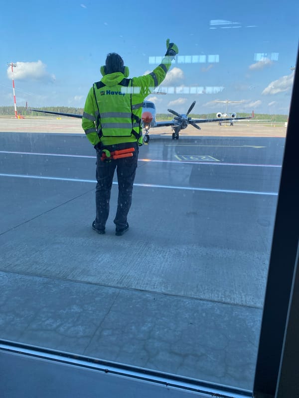 Ground crew directs aircraft operations at Skulte airport