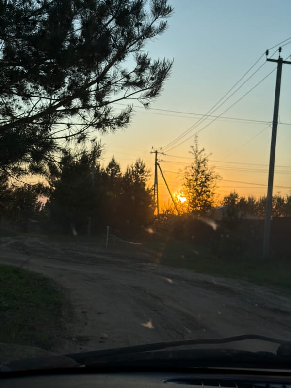 Woman enjoys sunset beer break on rural Russian roadside