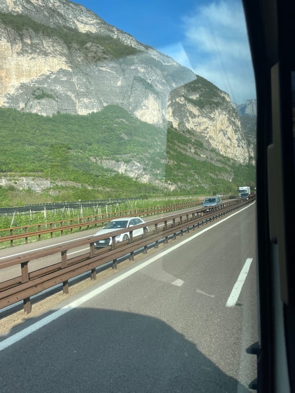 Morning traffic flows through mountain highway near Trento